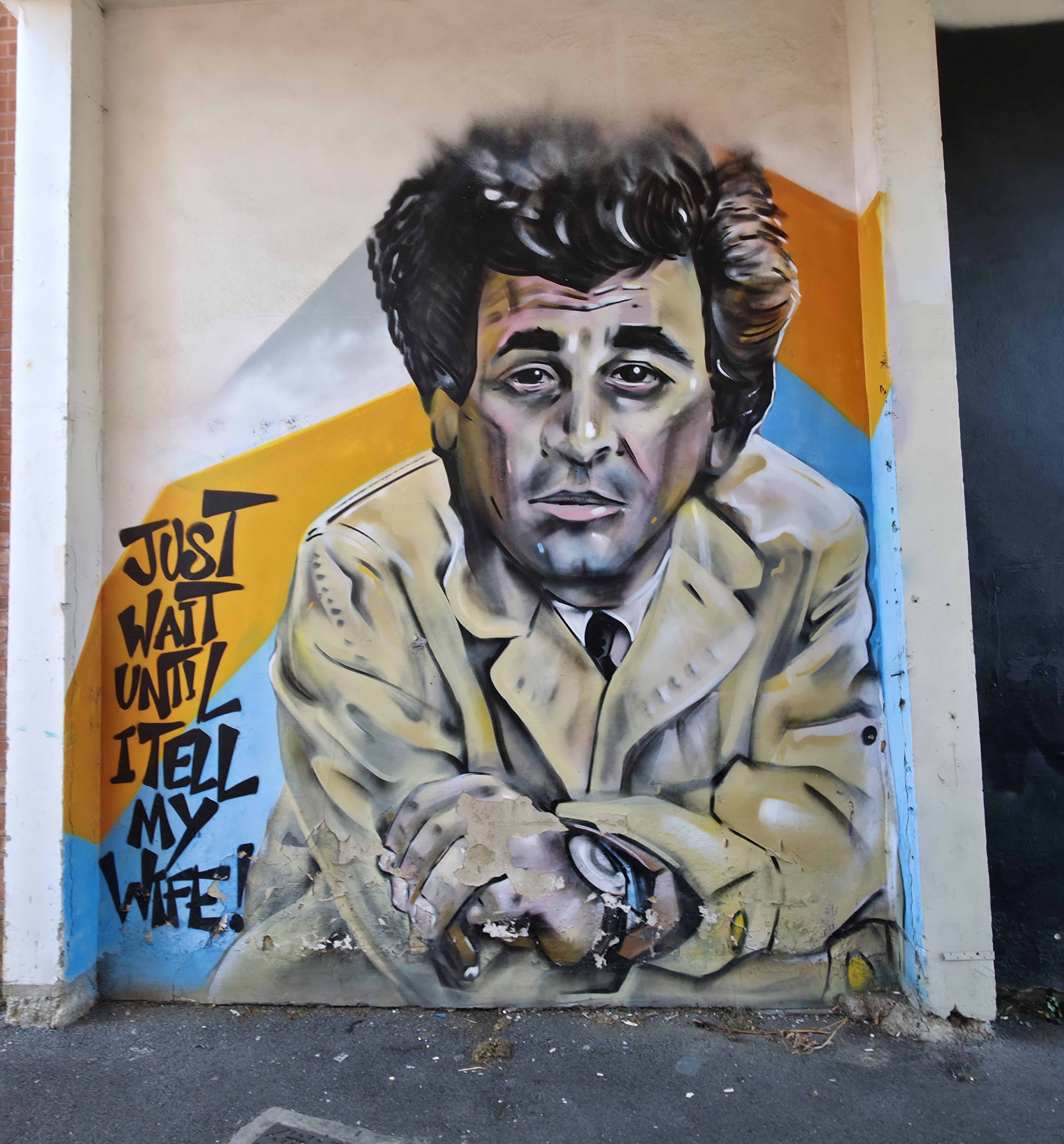 Photo of a man wearing a grey jacket and black hair with text saying just wait until I tell my wife, found in Albert Road, Southsea, Hampshire, United Kingdom. Photo taken by Baldi, A.K.A Amonn AL-Mahrouq.