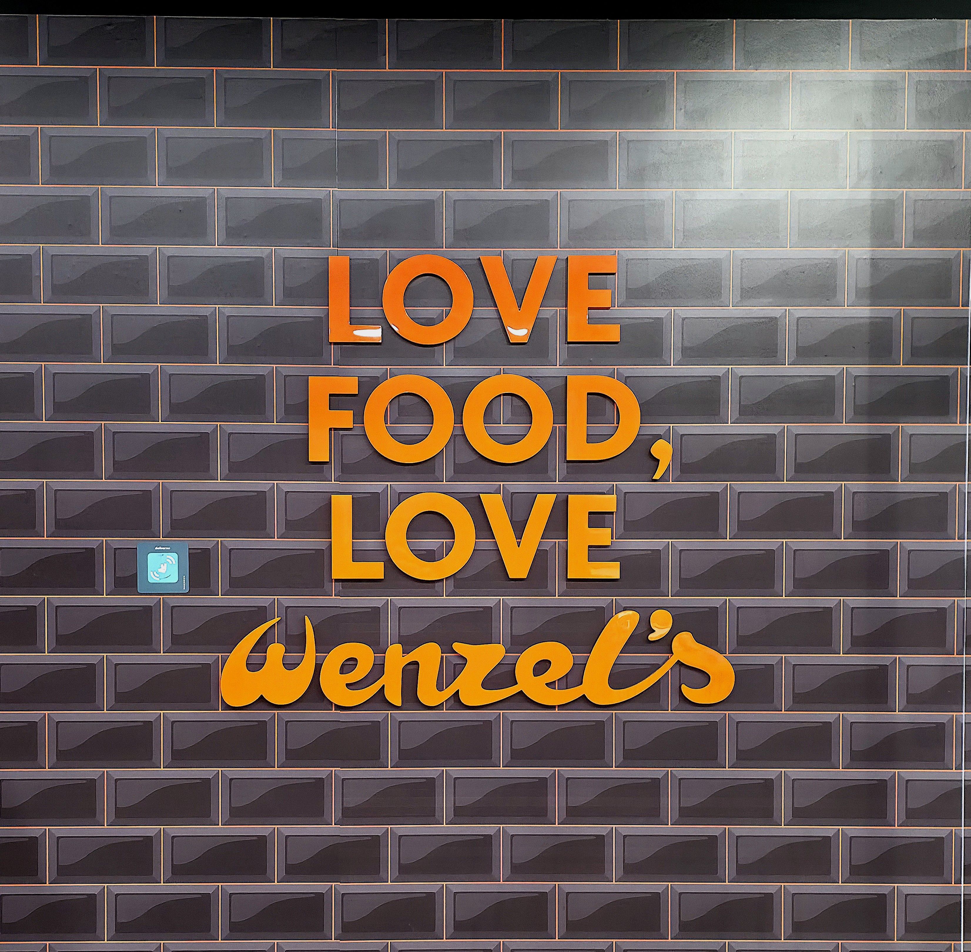 A photo taking in Wenzel's by Baldi, A.K.A Amonn AL-Mahrouq saying love food, love Wenzels